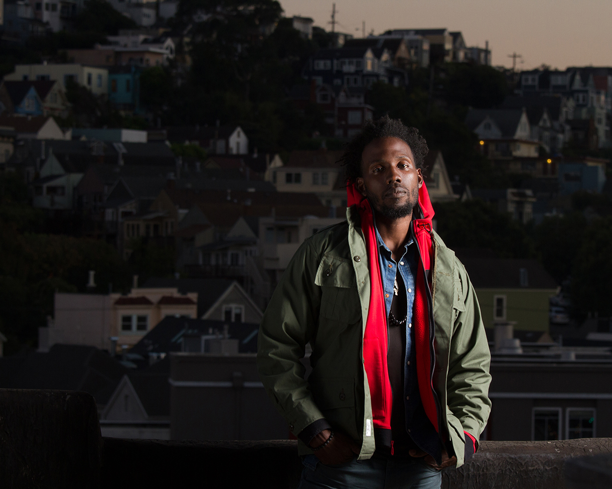 Jamaican Male Model in outerwear fashion on rooftop deck in San Francisco, CA.